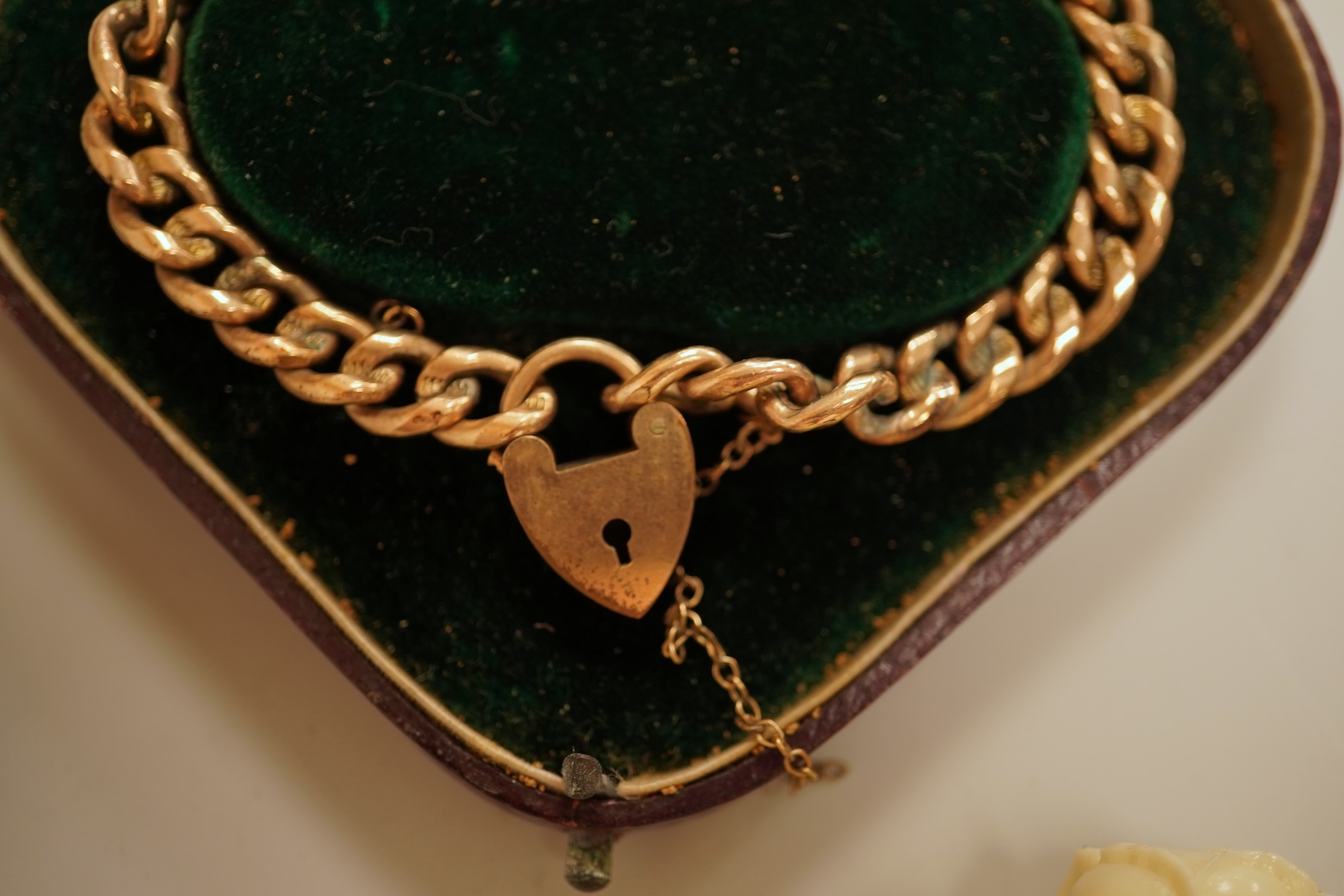 A small group of assorted jewellery including a gold plated curb link bracelet, silver brooch, simulated pearl necklace and costume.